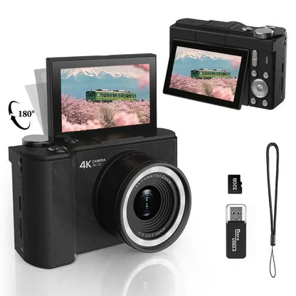 Black compact mirrorless camera with a 180-degree flip-out screen, shown with a lens, USB flash, memory card, and wrist strap on a white background.